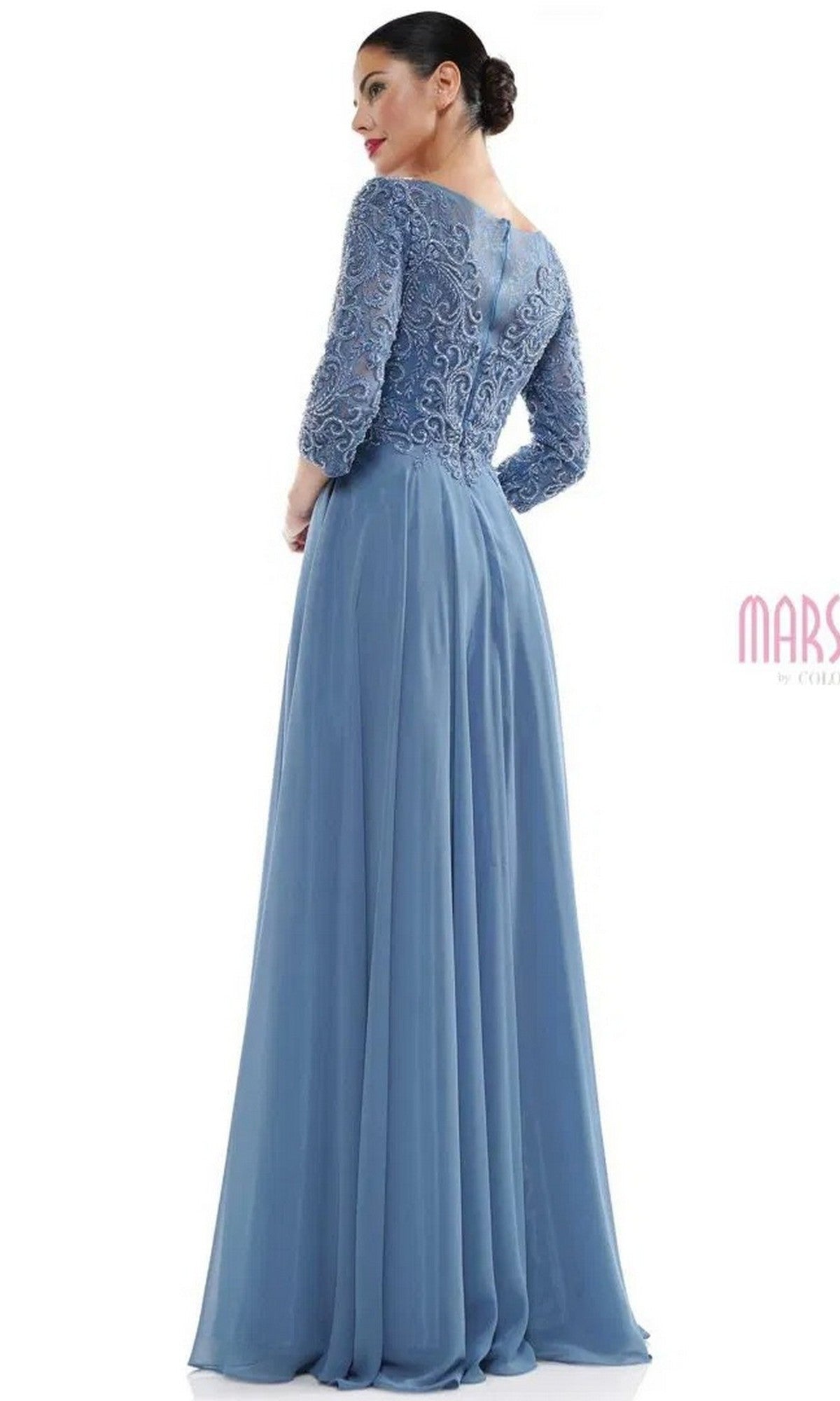 A woman is shown from the back wearing the Marsoni MV1052, a floor-length, light blue formal dress with lace long sleeves and a fitted bodice, against a plain white background.